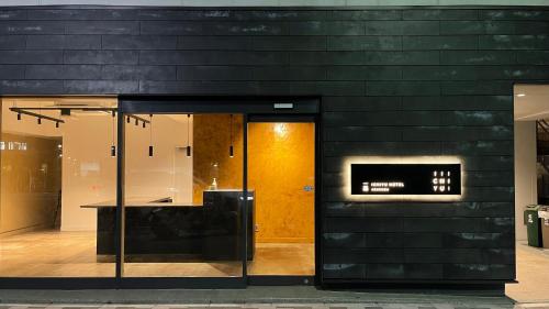 a black wall with a door in a building at ICHIYU HOTEL ASAKUSA in Tokyo