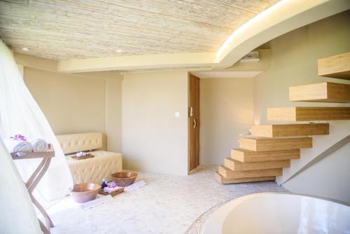 a bathroom with a sink and stairs in a room at Kappa Senses Ubud in Ubud