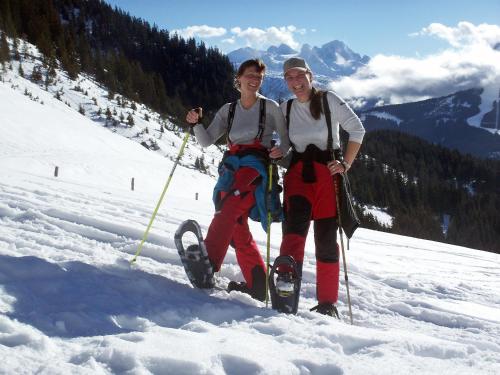 two women standing on top of a snow covered mountain at Landhaus Koller in Gosau