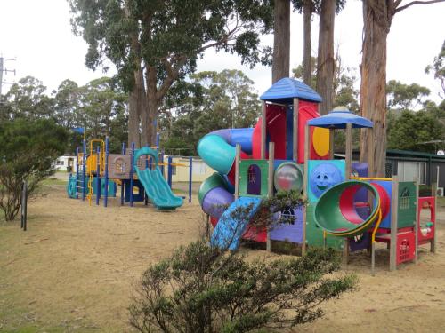 a row of playground equipment in a park at Captain Cook Holiday Park in Adventure Bay