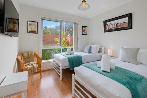 a bedroom with two beds and a window at SEArenity in Rosebud