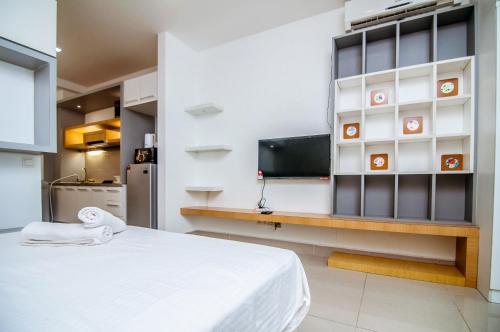 a room with a bed and a flat screen tv at Shaftsbury Cyberjaya by IdealHub in Cyberjaya