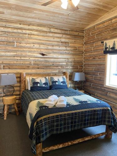 a bedroom with a bed in a log cabin at Alaska Knotty Pine B&B in Palmer