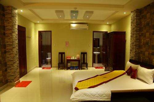 a bedroom with a bed with a surfboard on it at Minh Kieu Hotel in My Tho
