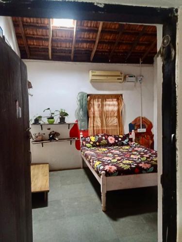 a bedroom with a bed in a room at The Wild Flower! in Anjuna