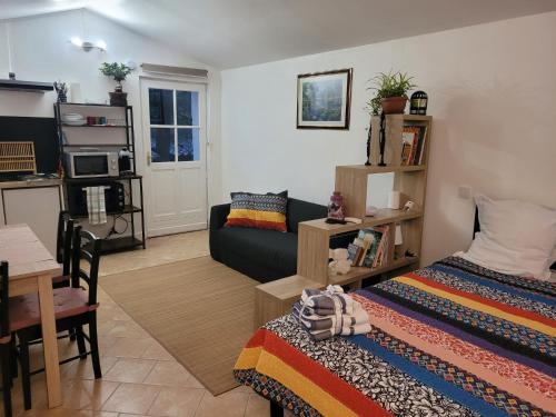 a living room with a bed and a couch at Domaine de La Mayonnette in La Crau