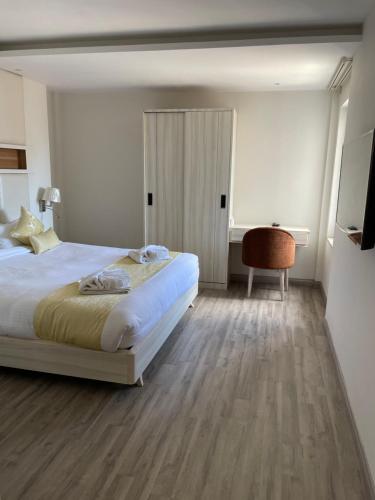 a bedroom with a bed and a table and a chair at Palmo Holiday Apartments in Kathmandu