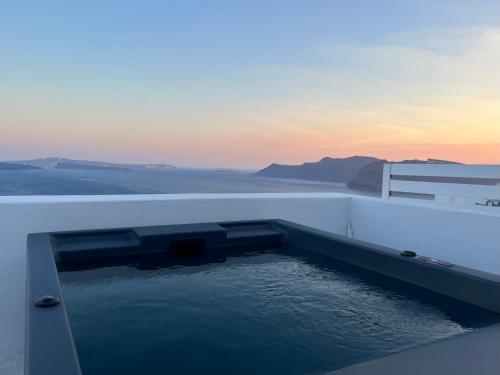 a pool of water on the side of a building at Imerti Suites in Oia