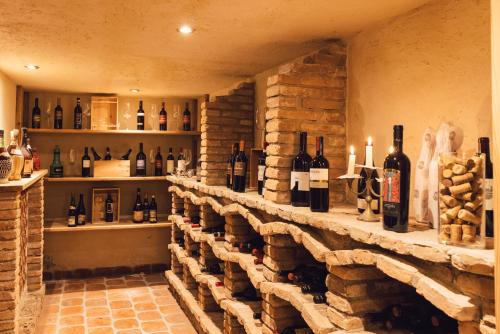 a bar with bottles of wine on a stone wall at Wellness Refugium & Resort Hotel Alpin Royal - Small Luxury Hotels of the World in Cadipietra