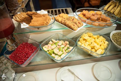 a buffet of different types of food on a table at Hotel Abigail Goradia's in Shirdi