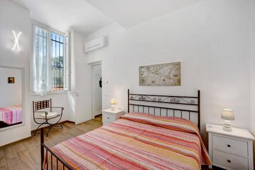 1 dormitorio con 1 cama grande y 2 ventanas en La Colombera, en Alassio