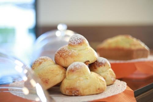 a pile of pastries on a plate on a table at Solmaris Tropea Rooms & Suites in Tropea