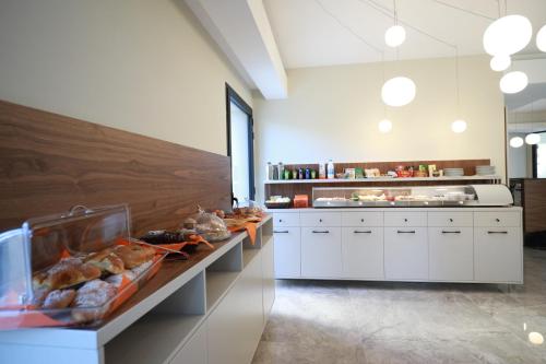 a large kitchen with a buffet of food on display at Solmaris Tropea Rooms & Suites in Tropea