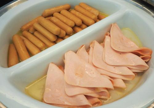 a container filled with meat and vegetables and carrots at Kingston Suites Bangkok in Bangkok