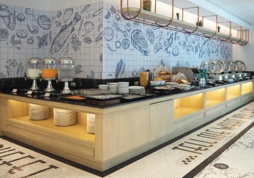 a kitchen with a counter with dishes on it at Kingston Suites Bangkok in Bangkok