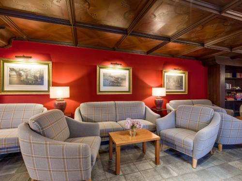 a waiting room with chairs and a table at Sporthotel Austria in Sankt Johann in Tirol