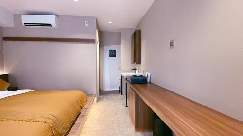 a bedroom with a bed and a sink in it at ICHIYU HOTEL ASAKUSA in Tokyo