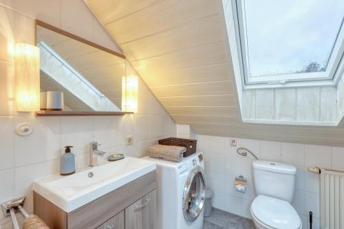 a bathroom with a washing machine and a sink at Ferienhaus Diane in Kirchheim