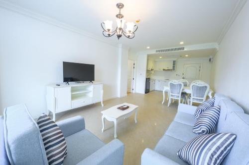 a living room with a blue couch and a table at Chateau de Khaoyai Hotel & Resort in Khao Yai