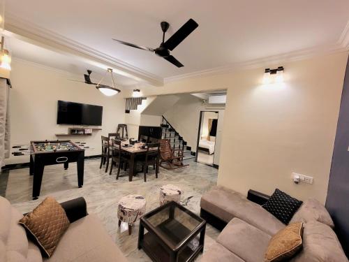 a living room with a couch and a table at Luna Villa by Angel Stay - Three Bedroom Villa in Lonavala in Lonavala