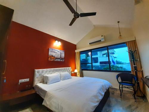 a bedroom with a large bed and a window at Luna Villa by Angel Stay - Three Bedroom Villa in Lonavala in Lonavala