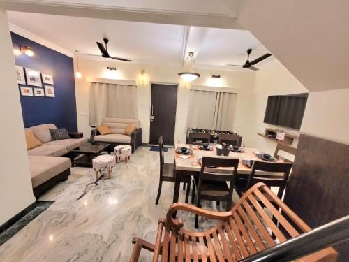 a living room with a table and a couch at Luna Villa by Angel Stay - Three Bedroom Villa in Lonavala in Lonavala