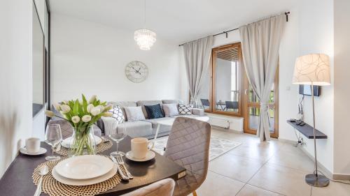 a living room with a table and a couch at Olympic Park I, Sun & Snow in Kołobrzeg