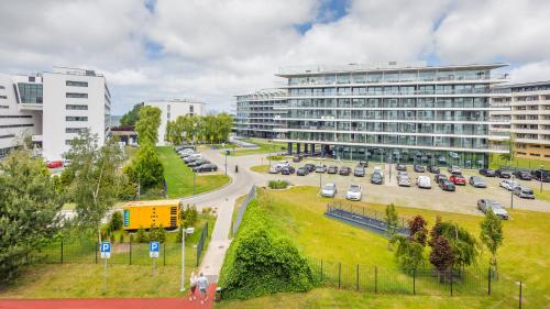 a city with a parking lot and a large building at Olympic Park I, Sun & Snow in Kołobrzeg