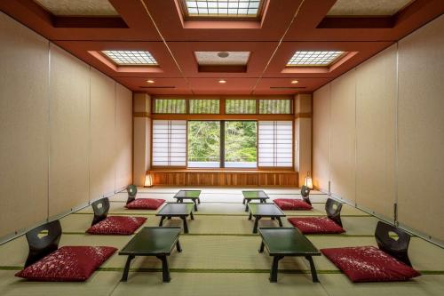 a large room with chairs and a large window at Nikko Nationalpark Kawamata Onsen KURA in Nikko