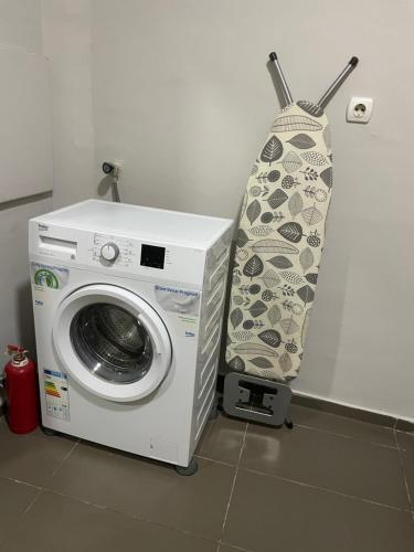 a washing machine with a curtain next to it at Dada Lux in Kumanovo