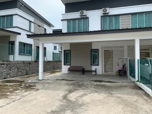 a house with a bench in front of it at Homestay Teratak Kasih Astana height in Sandakan