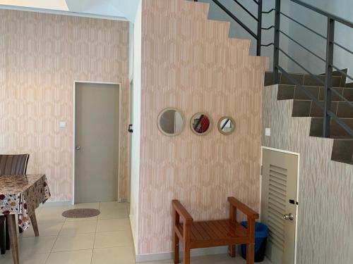 a room with a staircase and a wooden bench at Homestay Teratak Kasih Astana height in Sandakan