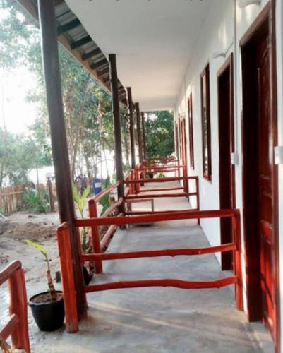a hallway of a building with red rails on it at Mangrove Beach Bungalows in Koh Rong Sanloem