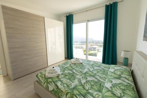 a bedroom with a bed and a large window at Villa Cristina - Relax - Piscina e Vista Mare in Castellammare del Golfo