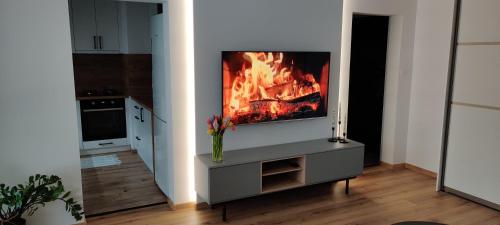 a living room with a tv with a fire in it at Apartment Terasa Kosice in Košice