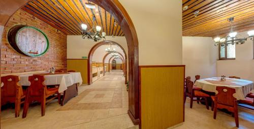 une salle à manger avec des tables et des chaises et un mur en briques dans l'établissement Hotel PRESLAV, aux Sables d'or
