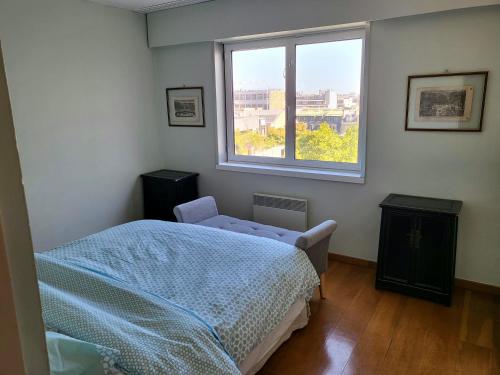 a bedroom with a bed and a window at Penthouse champs elysées above 5 stars hotel berri champs elysées in Paris