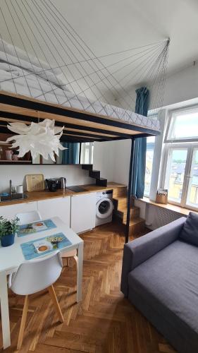 a living room with a bed and a table at Planet Hostel in Warsaw