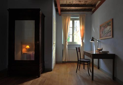 um quarto com uma secretária, uma mesa e uma janela em Bed and Breakfast Locanda Lugagnano em Cassinetta di Lugagnano