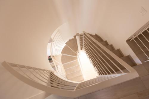a spiral staircase in a building with a window at Villa Cristina in Castellammare del Golfo