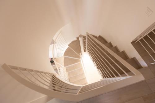 a spiral staircase in a building with a window at Villa Cristina - Relax - Piscina e Vista Mare in Castellammare del Golfo