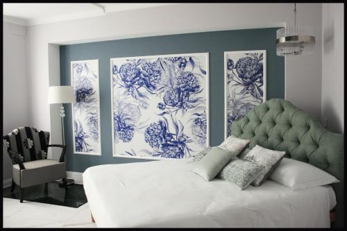 a bedroom with blue and white paintings on the wall at Casa Vacanze Borc dai Cucs in Faedis