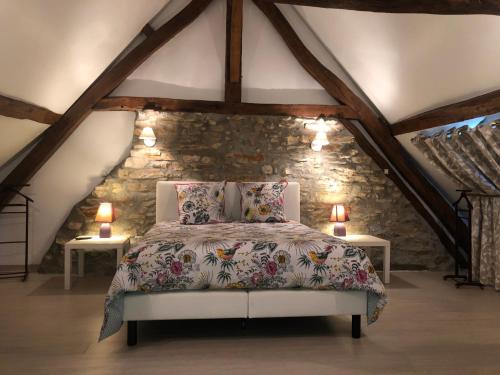 En eller flere senge i et værelse på Gîte des Bruyères