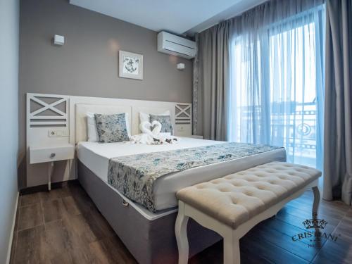 A bed or beds in a room at Cristiani Hotel Sozopol