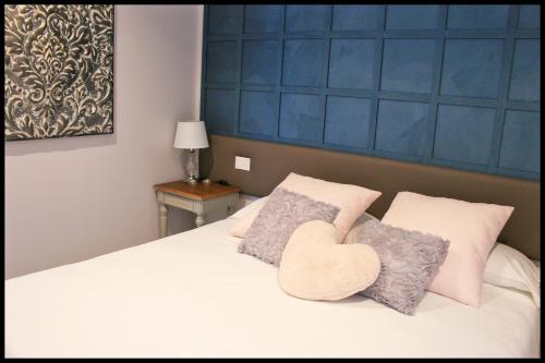 a bedroom with a bed with a heart pillow on it at Casa Vacanze Borc dai Cucs in Faedis