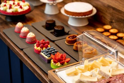 a table with different types of pastries and desserts at Calepina Alpine Suite in Trento