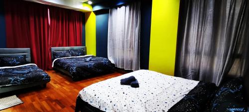 two beds in a room with colorful walls at KLCC Amazing Robots Homestay 4Bedrooms (13pax) in Kuala Lumpur