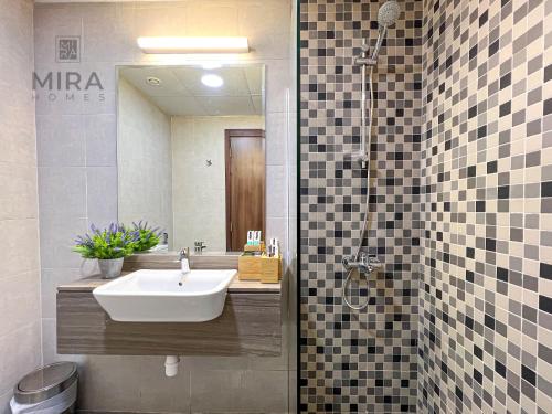 a bathroom with a sink and a shower at Mira Holiday Homes - Serviced studio with balcony in Dubai