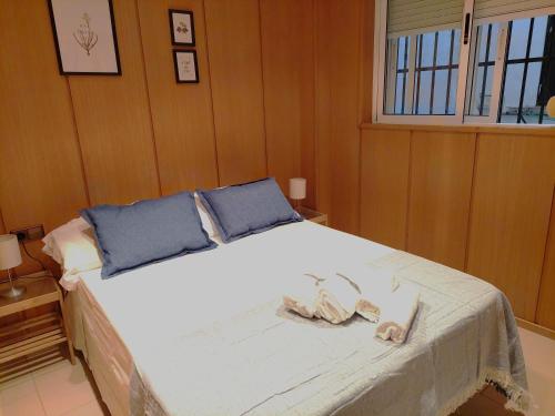 Un dormitorio con una cama con dos pares de sandalias. en Mercat Silence, en Valencia
