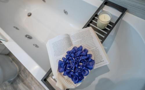 a book with a blue flower sitting on a table at La Casa Suites Windsor - Two 2-bedroom apartments in Windsor